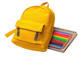Yellow backpack with colored pencils on notebook