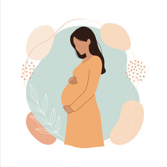 Beautiful pregnant woman holding her belly with a warm gentle smile. .