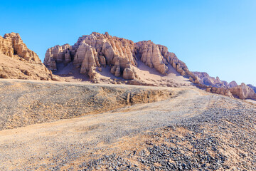 Desert road and spectacular yardang landform mountain natural landscape in Xinjiang, China.