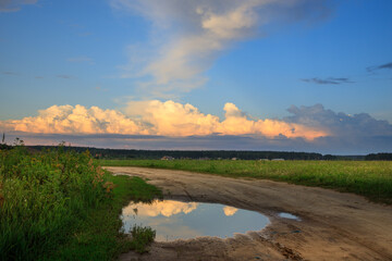 Road with a puddle of water in the middle of it