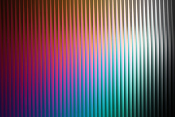 Abstract background featuring a vertical ribbed texture with a gradient of warm and cool colors, transitioning from deep red and magenta to bright cyan and silver