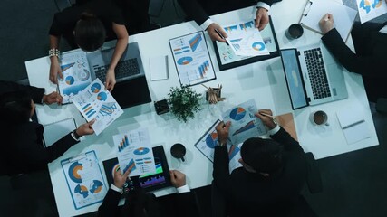 Top view of businesswoman sit at seat and start to analyze stock market data with diverse business team at meeting table with marketing chart document and tablet display financial report. Directorate. - Powered by Adobe