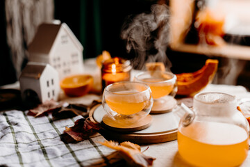 Two steaming orange pumpkin teas glowing in autumn light. Cozy still life for seasonal comfort and warmth.