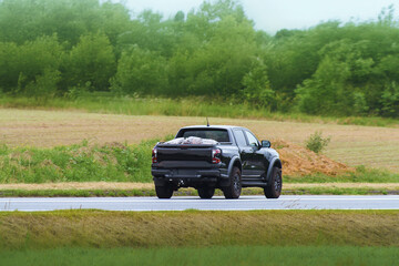 Fototapeta premium Pickup truck crossing rural scenic highway