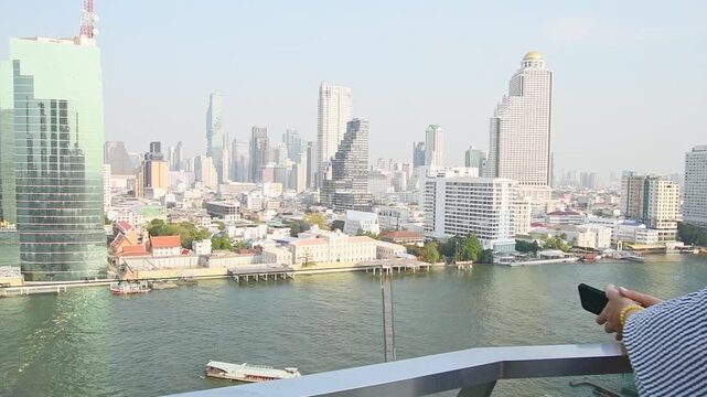Bangkok, Thailand - 11th february, 2024: Attractive elegant woman tourist wear dress enjoy shopping mall look out famous viewpoint over river in southeast asia popular destination Bangkok city