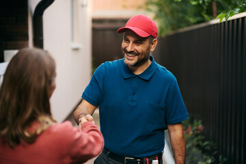 Happy home repairman responding to customer's call.