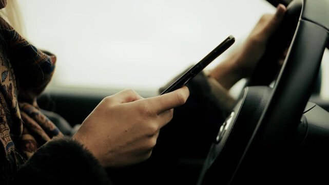 Dangerous distracted driving behavior . Driver texting on smartphone while operating vehicle