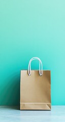 Brown paper shopping bag against aqua-colored wall