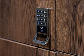 Close up of electronic locker lock with keypad and NFC access in a public changing or gym locker room