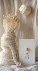 Neutral yarn still life with dried flowers and knitting needles