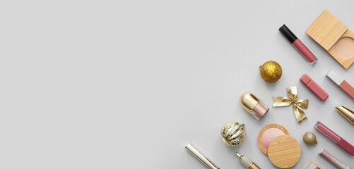 Christmas decorations and cosmetics on light background with space for text, top view