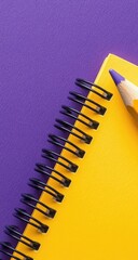 Yellow notepad & purple pencil against a purple surface