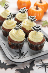 Halloween cupcakes decorated with bat and spider decorations