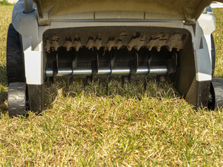 Closeup of lawn scarifier back showing scarifying mechanism