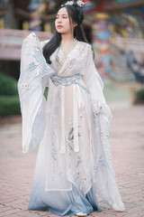 Elegant Young Woman in Traditional Chinese Hanfu Dress Outdoors