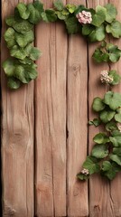 Green vines with small pink flowers climbing on weathered wooden planks creating a natural border.