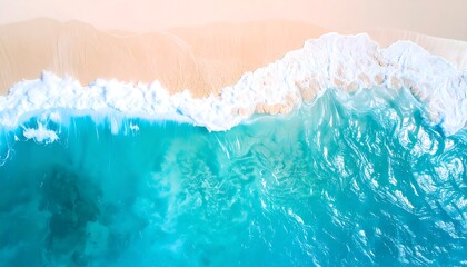 Aerial view of a turquoise ocean meeting a beige beach
