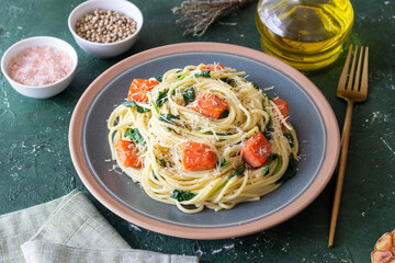 Pasta spaghetti with salmon, spinach, and cheese. Italian cuisine. Healthy eating.