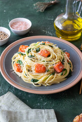 Pasta spaghetti with salmon, spinach, and cheese. Italian cuisine. Healthy eating.