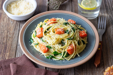 Pasta spaghetti with salmon, spinach, and cheese. Italian cuisine. Healthy eating.