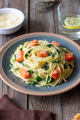Pasta spaghetti with salmon, spinach, and cheese. Italian cuisine. Healthy eating.