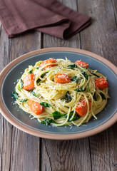 Pasta spaghetti with salmon, spinach, and cheese. Italian cuisine. Healthy eating.