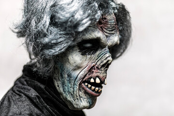 Portrait of a scary zombie with gray hair