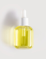 bottle of serum on a light background