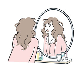 鏡を覗き込むパジャマ姿の女性