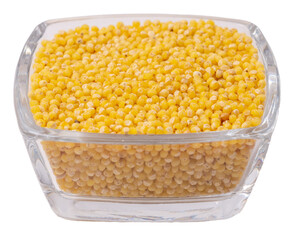 Isolated millet groats in glass on a white background, side view, copy space