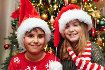 Merry Christmas, happy children portrait in Santa Hat Having fun Smiling Happy Emotions, selfie and funny together in home. Xmas celebration and holiday. lifestyle, New Year,