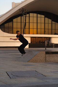 Man performing a trick on roller skates at sunset, urban environment