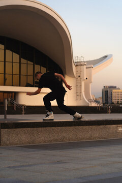 Man performing a trick on roller skates at sunset, urban environment