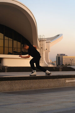 Man performing a trick on roller skates at sunset, urban environment