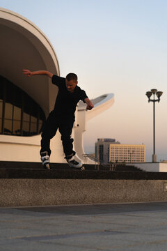 Man performing a trick on roller skates at sunset, urban environment