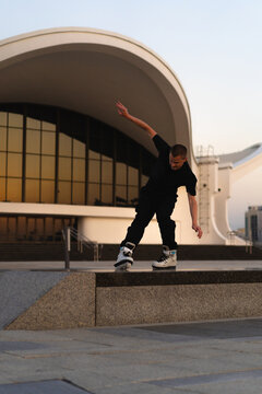 Man performing a trick on roller skates at sunset, urban environment