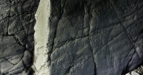 Unique rock surfaces showcase detailed textures and patterns in a natural environment, capturing the beauty of geology and time at a remote location.