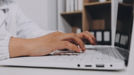 Telemedicine concept. Asian woman doctor talking to online patient on laptop computer sitting at clinic office desk giving online consultation for domestic health treatment. remote medical appointment