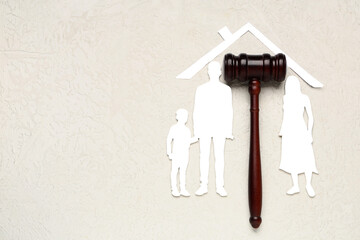 Judge's gavel with figures of family and paper house on grunge white background