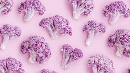 Purple cauliflower florets as minimal creative pattern on pastel pink, food photo banner. Vivid vegetable healthy organic food concept. Trend Flat lay arrangement for modern design, healthy lifestyle