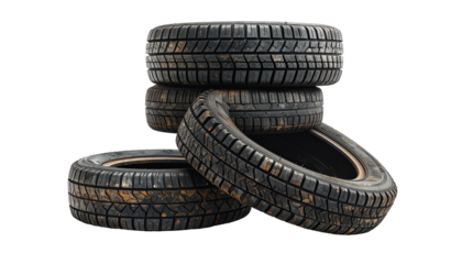 Stacked, weathered tires on black backdrop