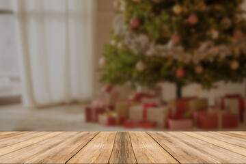 Wood table top on blur with bokeh christmas tree background - can be used for display or montage your products.
