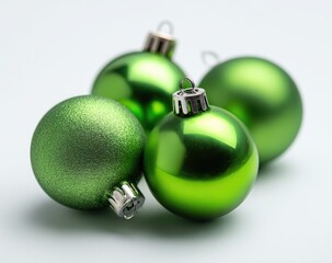 Close-up of four vibrant green Christmas ornaments
