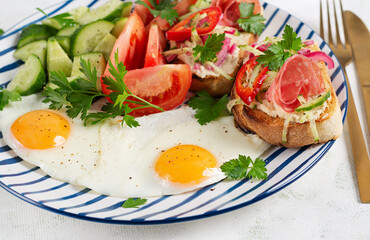 Fried Eggs with Toast and Vegetables on Plate