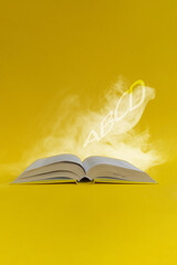 Open book with letters flying out of it on yellow background