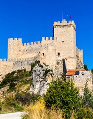 Fototapeta premium Stone Fortress on Hillside Under Blue Sky in Daylight