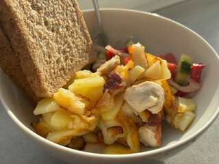 A popular Slavic food in the form of fried potatoes with chicken fillet and salad