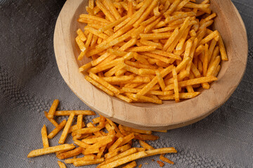 Fried chips sticks, finger potato chips, golden shoestring fries pile, French fries