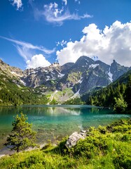 Stunning mountain lake scene with clear turquoise water and snow-capped peaks