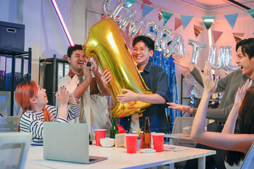 Fototapeta premium Excited office staff celebrate their 1st prize success party with cheerful joy, holding balloons and a shiny trophy together, smiling proudly in the office after achieving victory and teamwork success